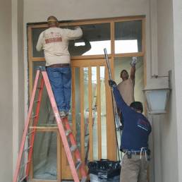 Workers installing door at clients home