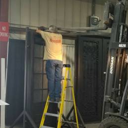 Worker customizing door at Iron Doors Arizona
